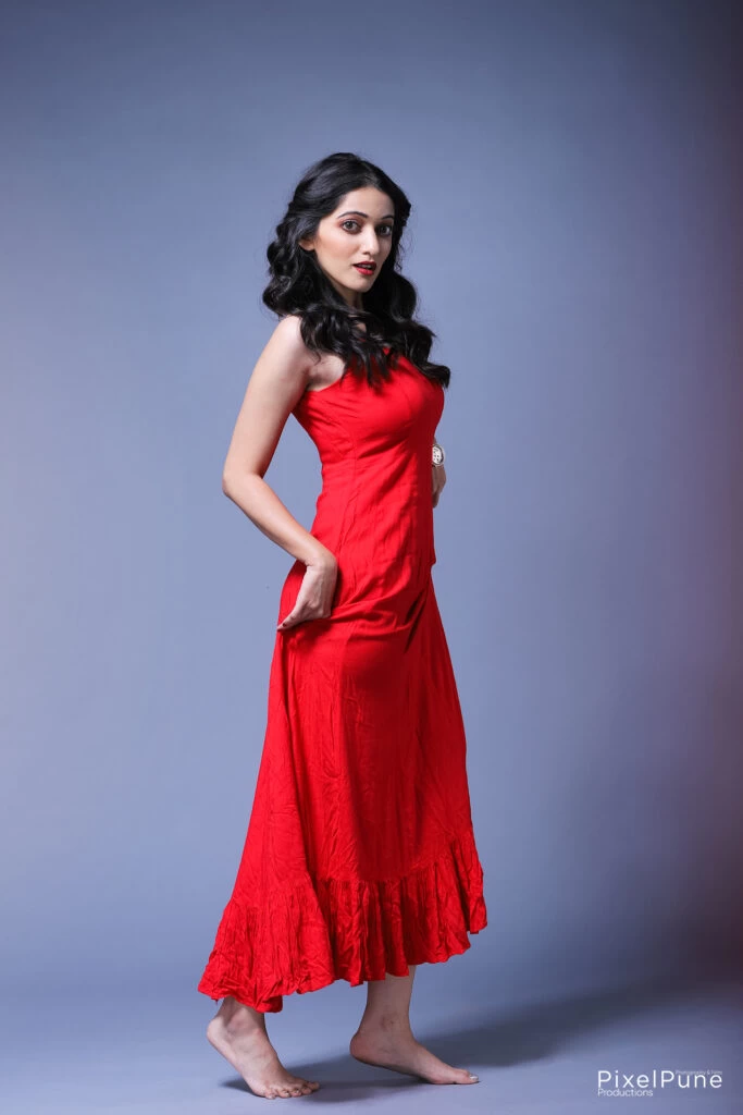 Manasi Patwardhan in red outfit holding roses