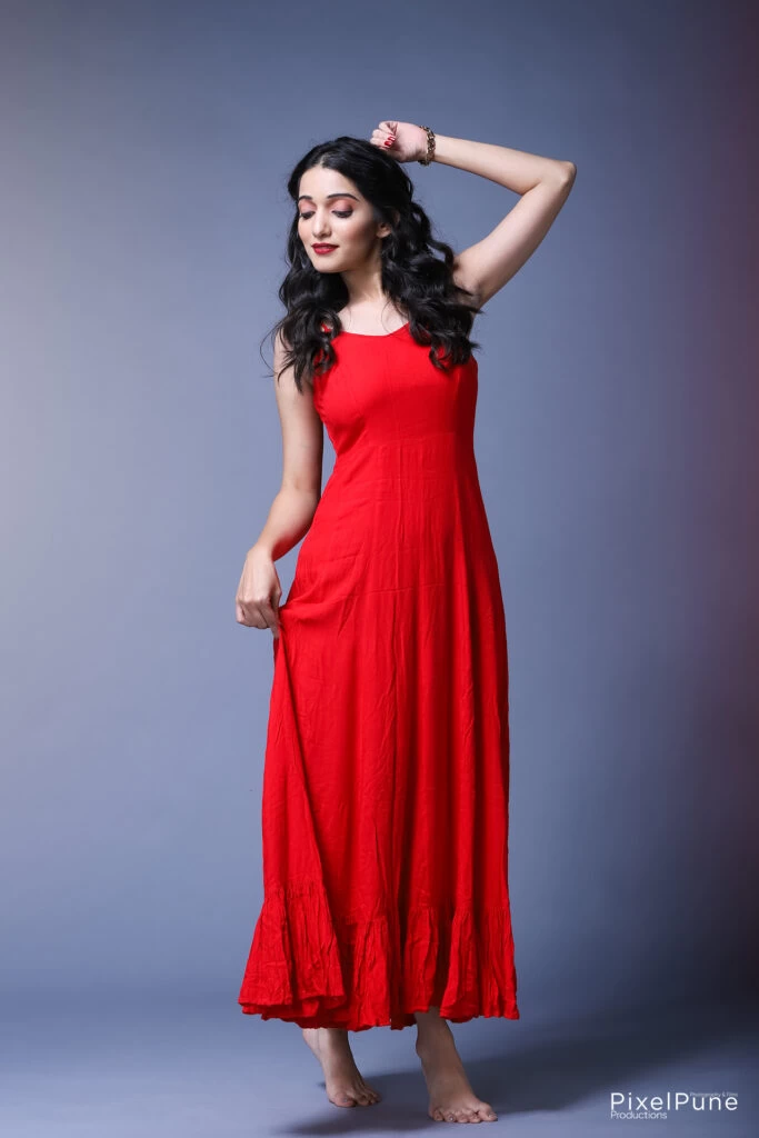 Manasi Patwardhan in red outfit holding roses