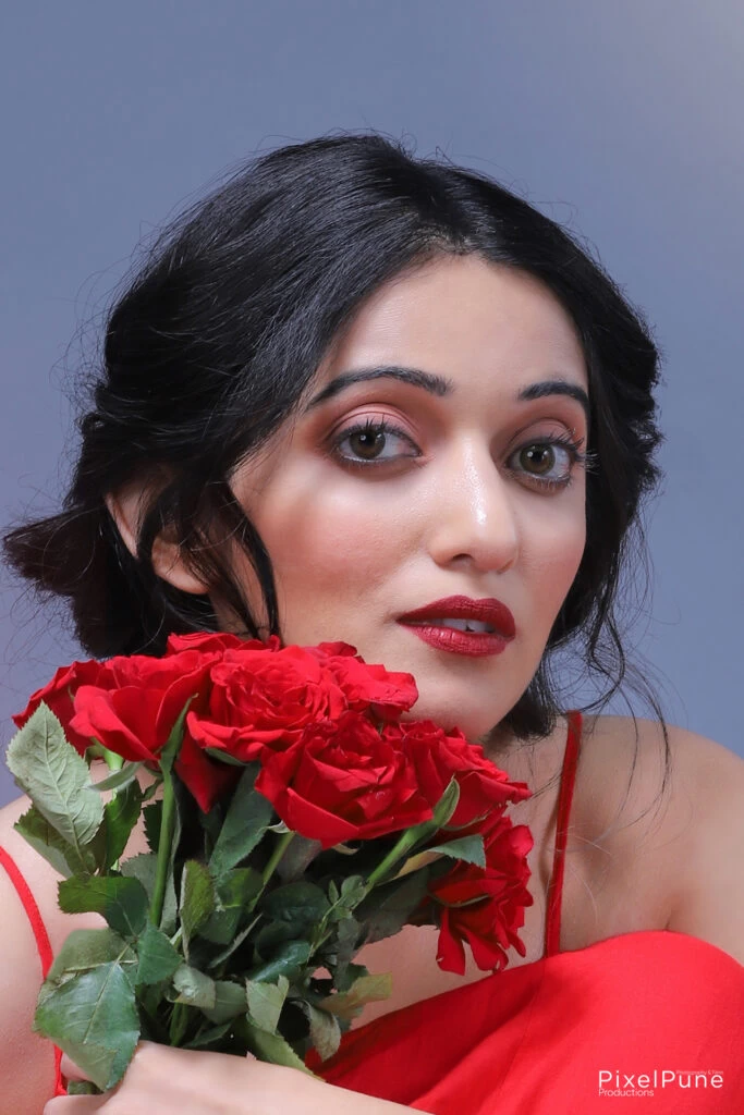 Manasi Patwardhan in red outfit holding roses